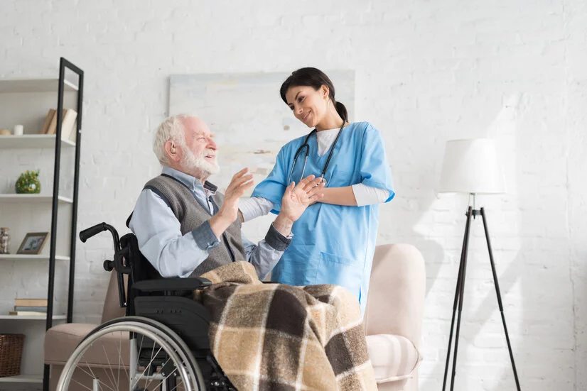 Pflegefachkraft mit Senior im Rollstuhl